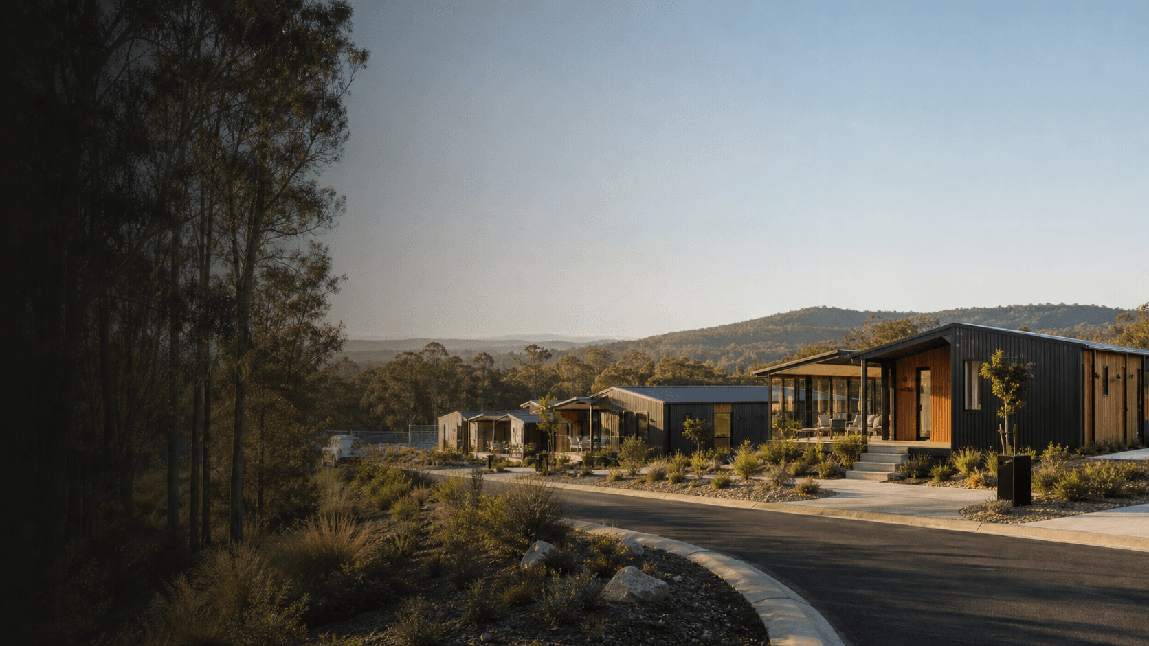 A modular housing development set among Australian native trees.