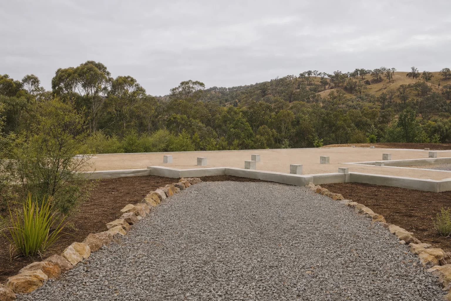 Prepared modular-home site with foundations and native landscape